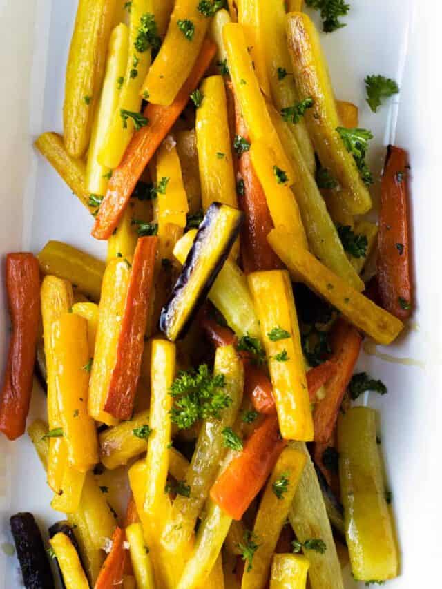 An overhead shot of honey roasted carrots on a white plate.