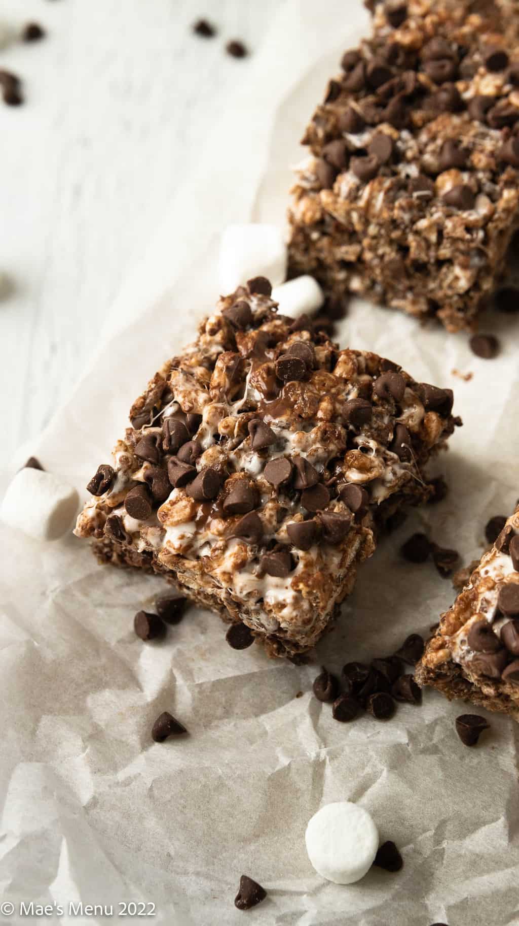 An up-close overhead shot of a chocolate rice crispy treat on parchment paper.