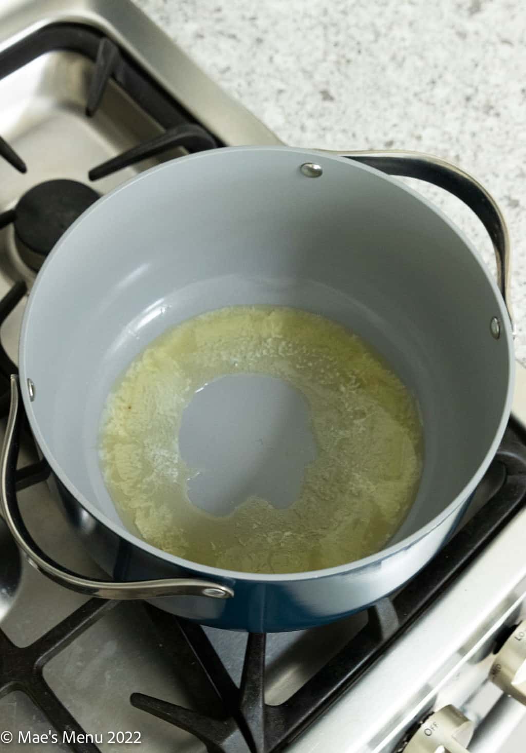Melting butter in a large pan.