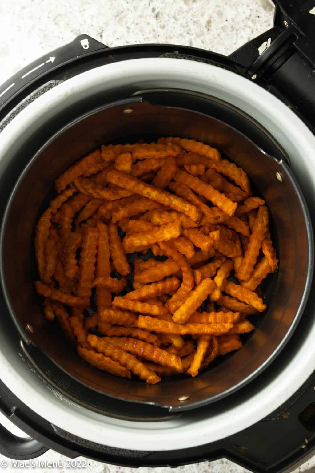 An overhead shot of a basket of sweet potato fries.