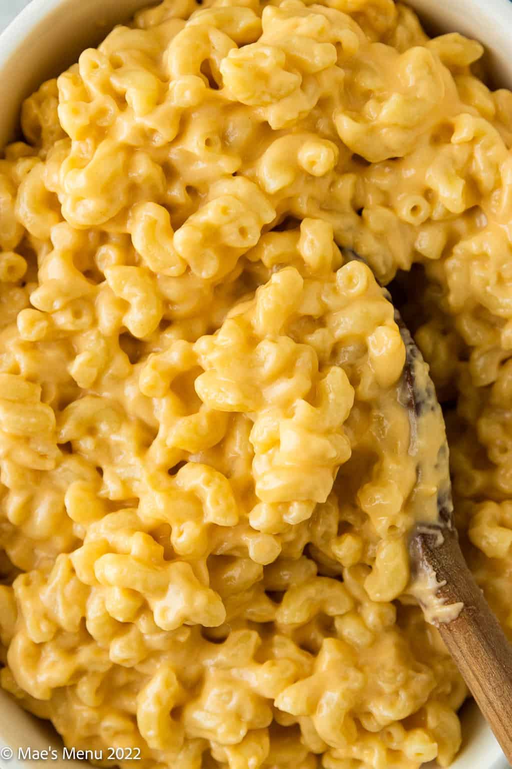 An up-close overhead shot of a white bowl of Mac and cheese.