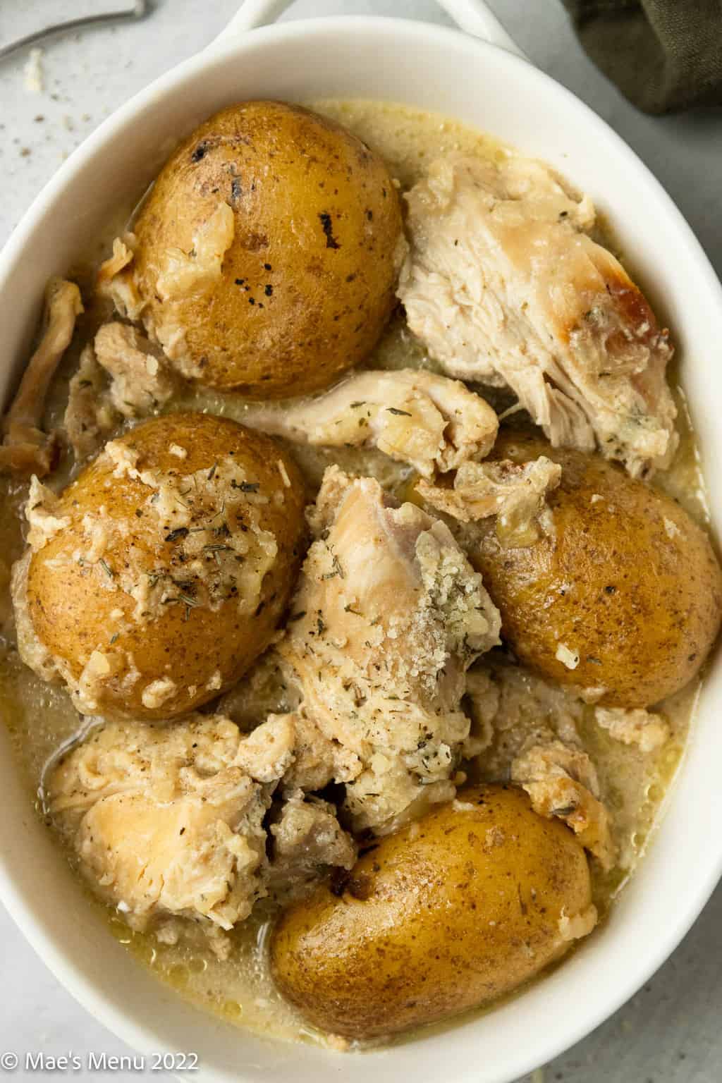 An up-close overhead shot of a bowl of instant pot chicken and potatoes