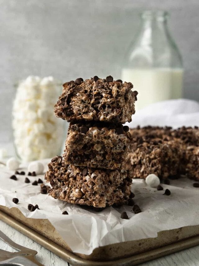 A stack of chocolate Rice Krispies on a metal baking sheet.