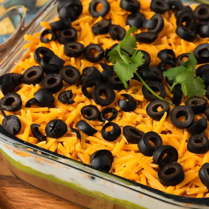 An up-close angled shot of a dish of Mexican bean dip.