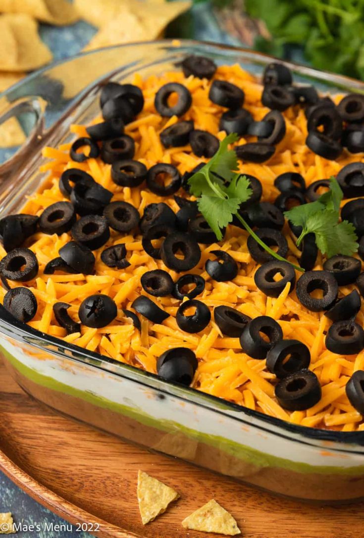 An up-close angled shot of a dish of Mexican bean dip.