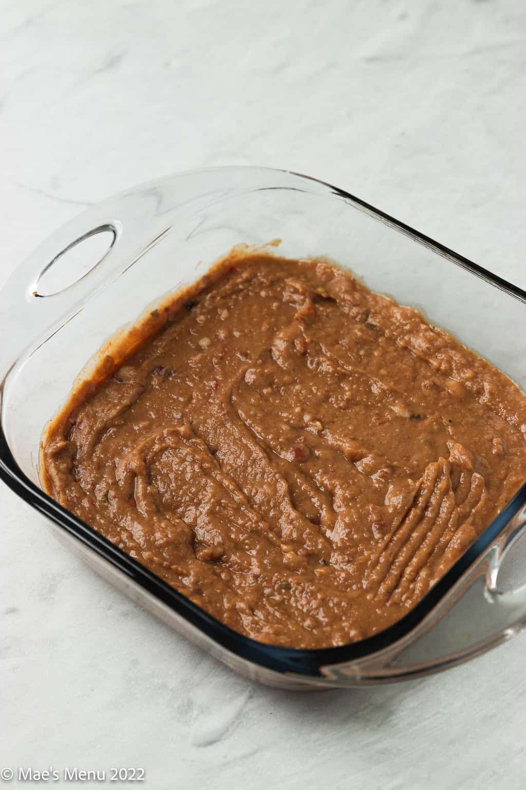 Make Mexican bean dip with the bottom layer of refried beans in the clear dish.