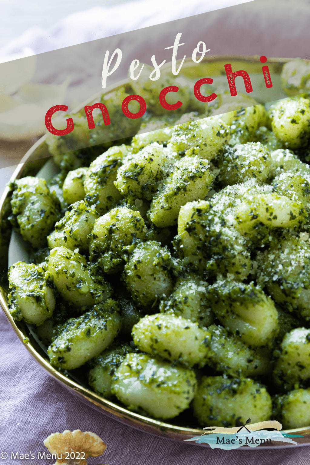 A pinterest pin for pesto gnocchi with an up-close shot of a bowl of gnocchi. 