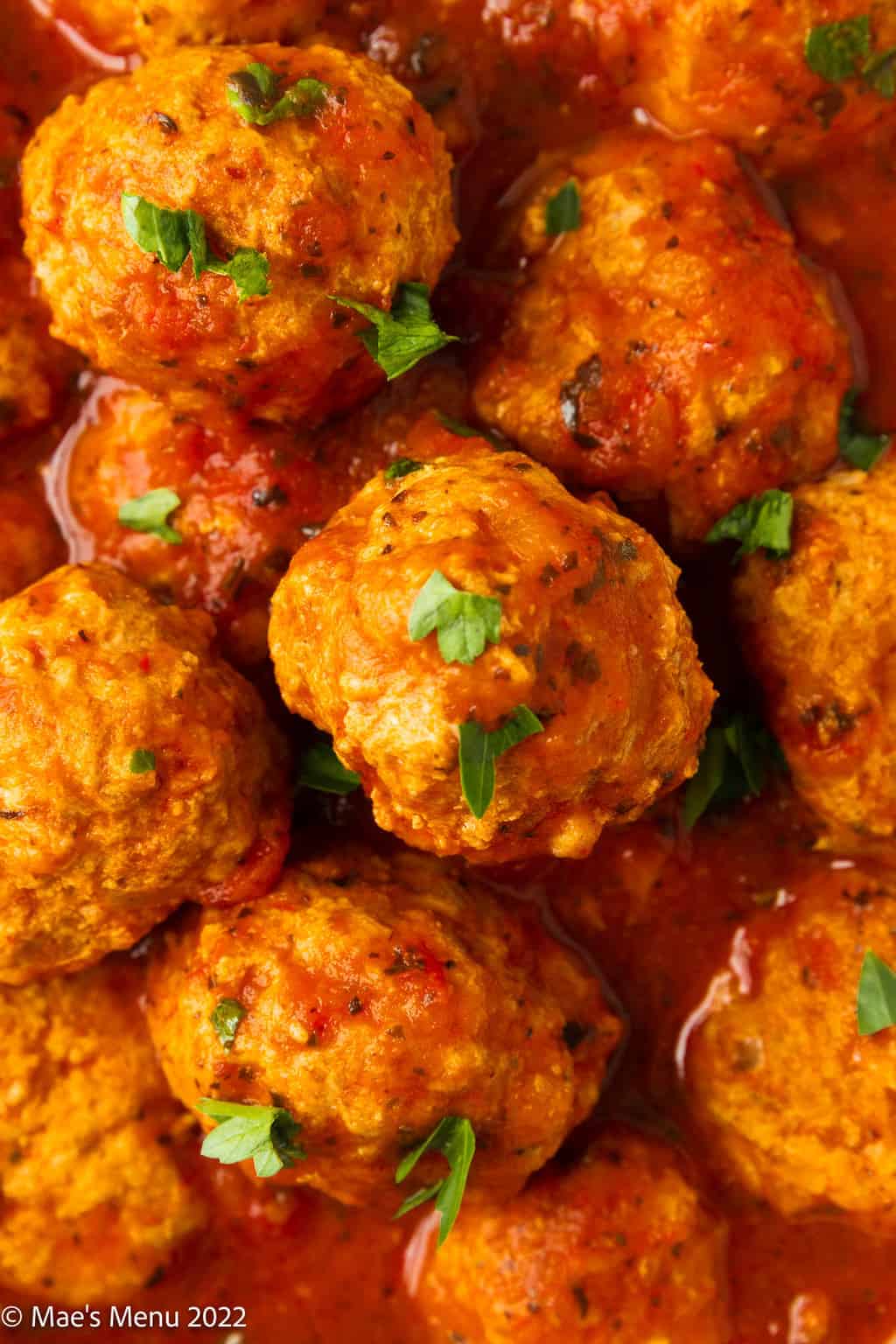 An up-close overhead shot of meatballs in sauce.