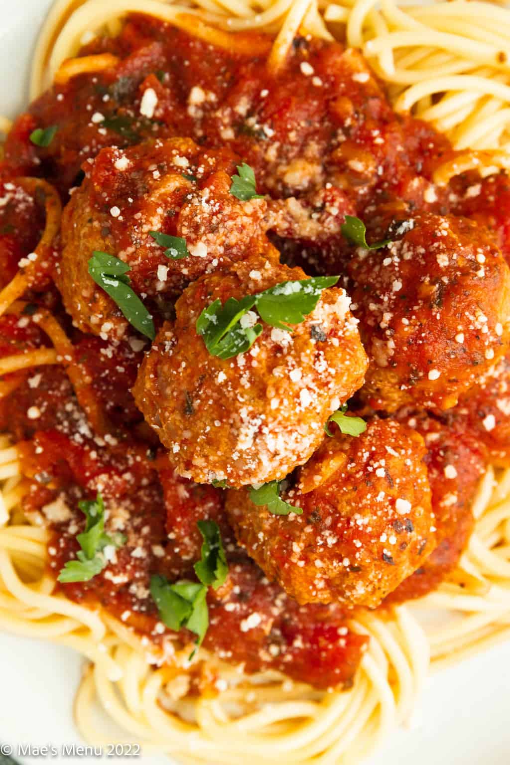 An up-close overhead shot of meatballs and spaghetti.
