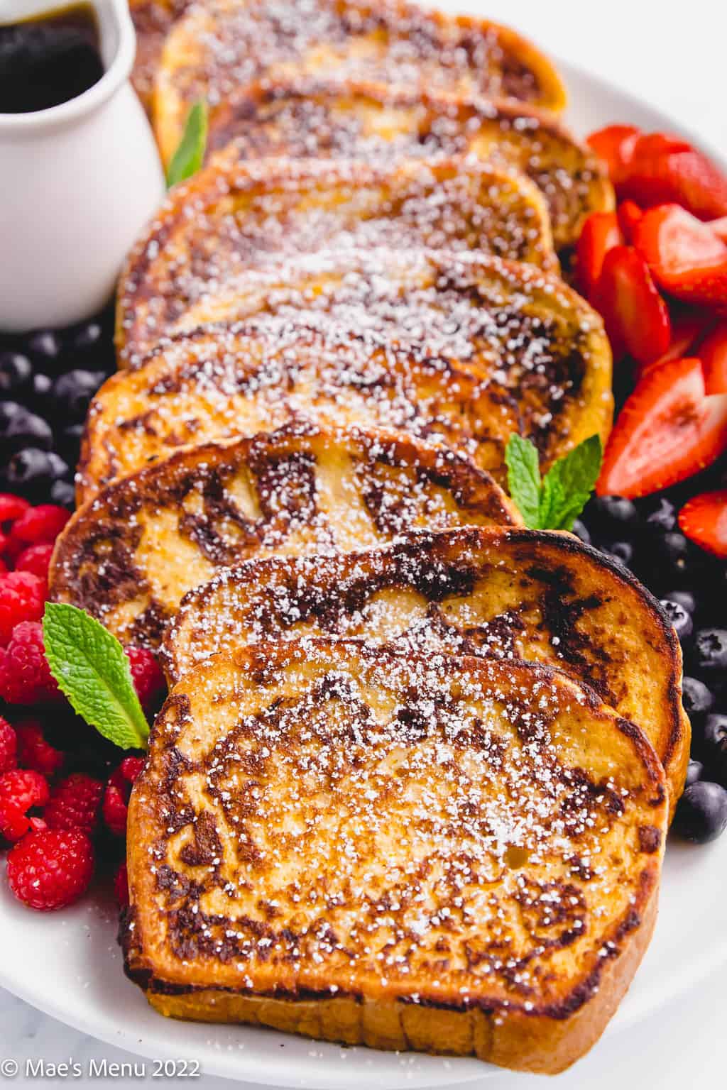 A plate of brioche french toast with berries.
