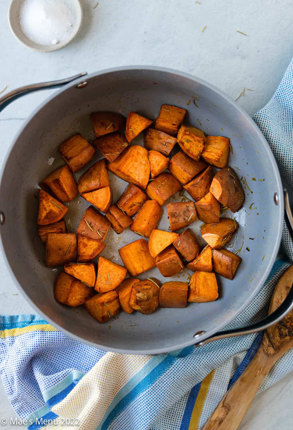An overhead shot of a Dutch oven of roasted sweet potatoes.