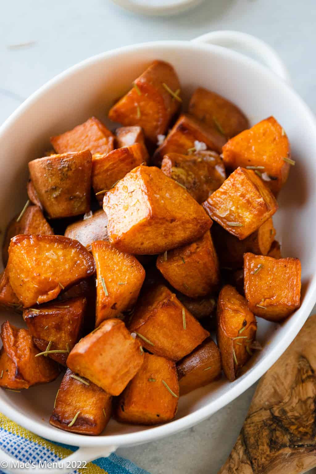 An up-close shot of a white dish of Dutch oven sweet potatoes.