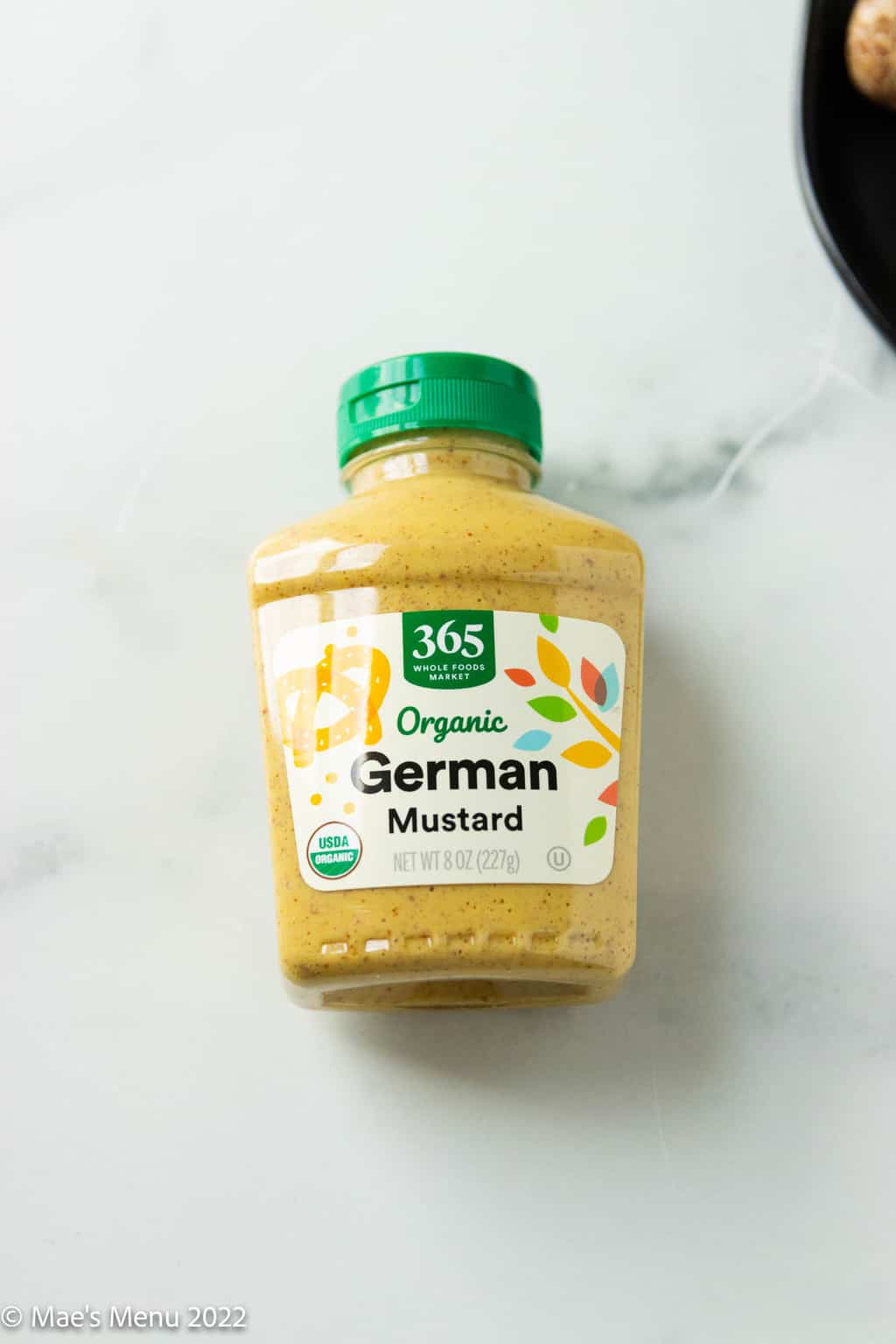 An up-close overhead shot of a bottle of organic German mustard.