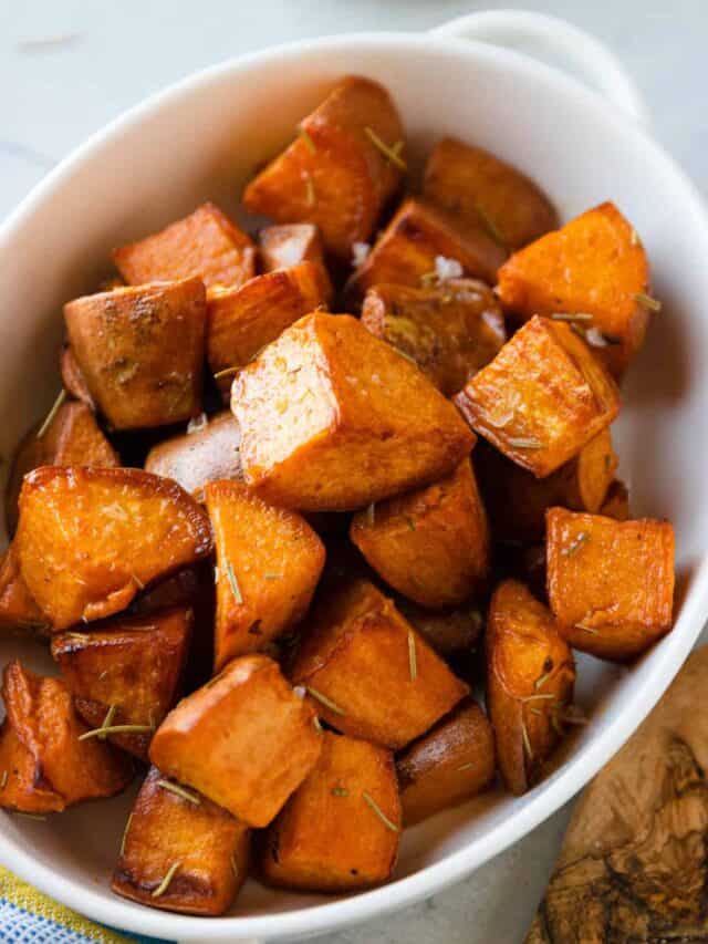 An up-close shot of a white dish of Dutch oven sweet potatoes.