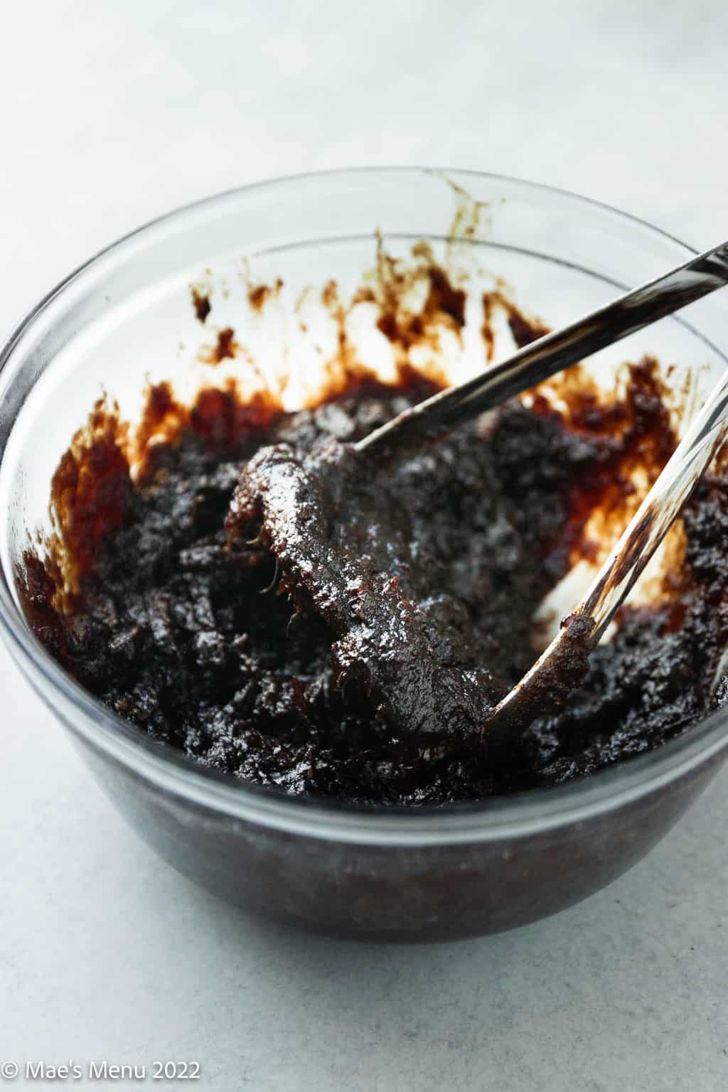 Mashed dates and raisins in a medium mixing bowl.