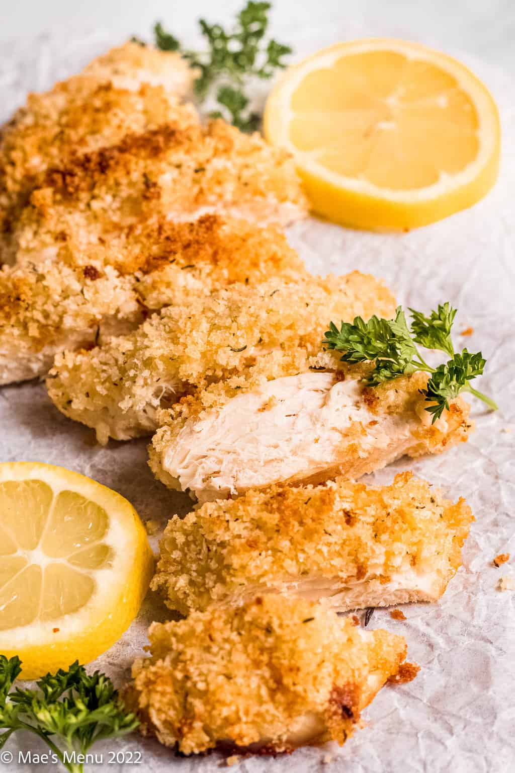 Baked panko chicken breasts with lemon and parsley.