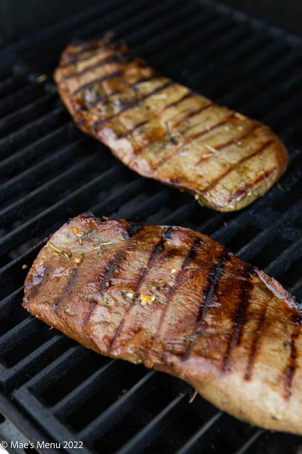 Flat iron steak on the grill grates.