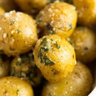 An up-close shot of instant pot potatoes seasoned with parsley and parmesan cheese.