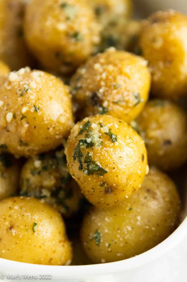 An up-close shot of instant pot potatoes seasoned with parsley and parmesan cheese.