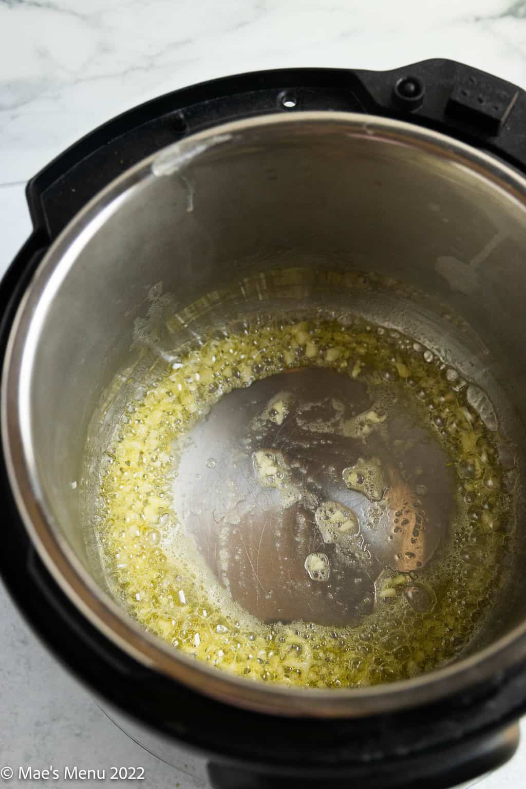 Minced garlic sauteing in garlic and olive oil.