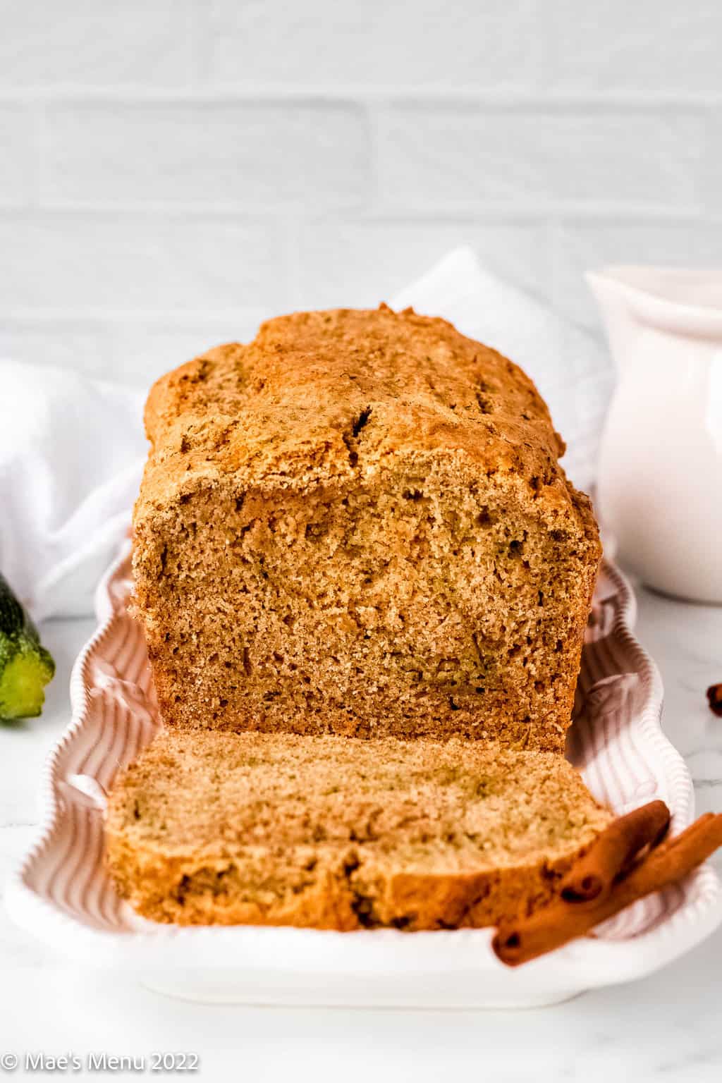 A side shot of a a loaf of sliced gluten-free zucchini bread.