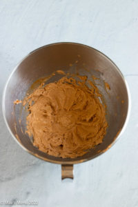 An overhead shot of a mixing bowl of whipped cream cheese, sour cream, and taco seasoning.