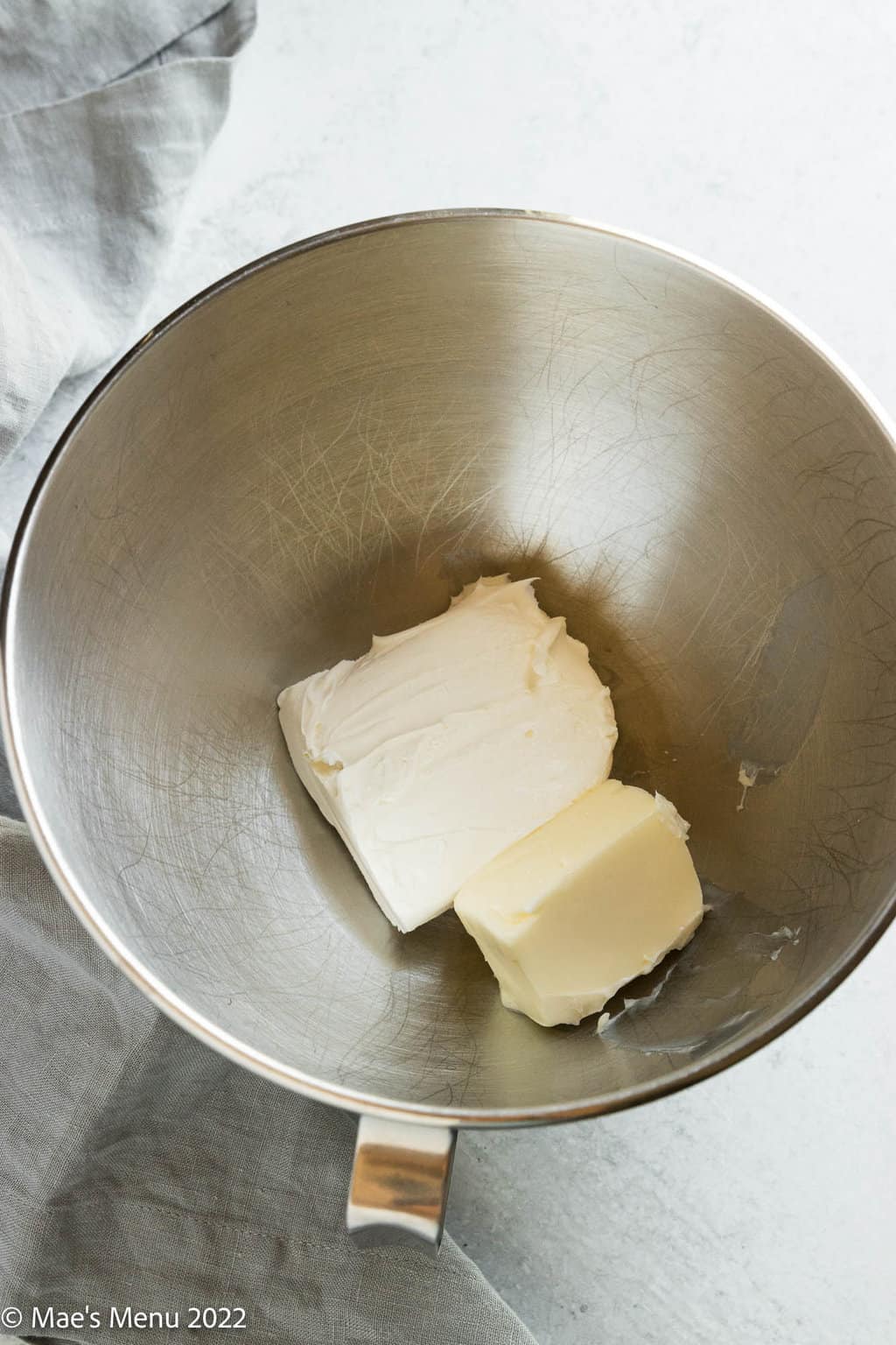 A mixing bowl with butter and cream cheese.