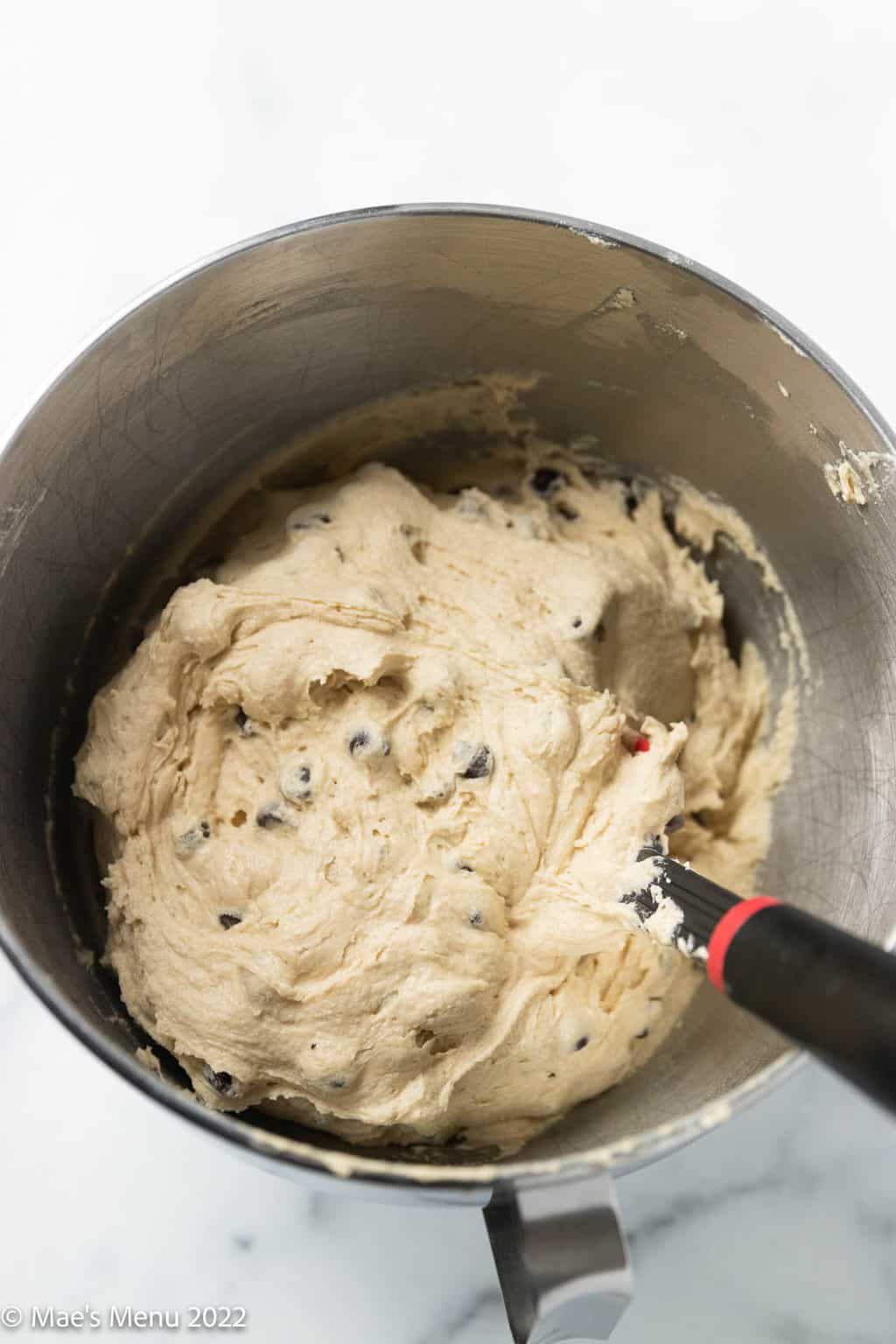 An overhead shot of a mixing bowl of dairy free chocolate chip cookie dough.