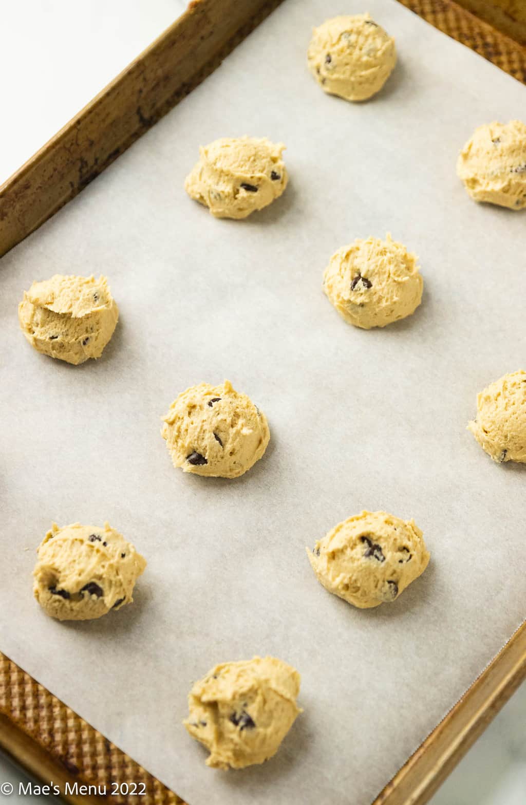 An overhead shot of a cookie sheet of dairy free chocolate chips.