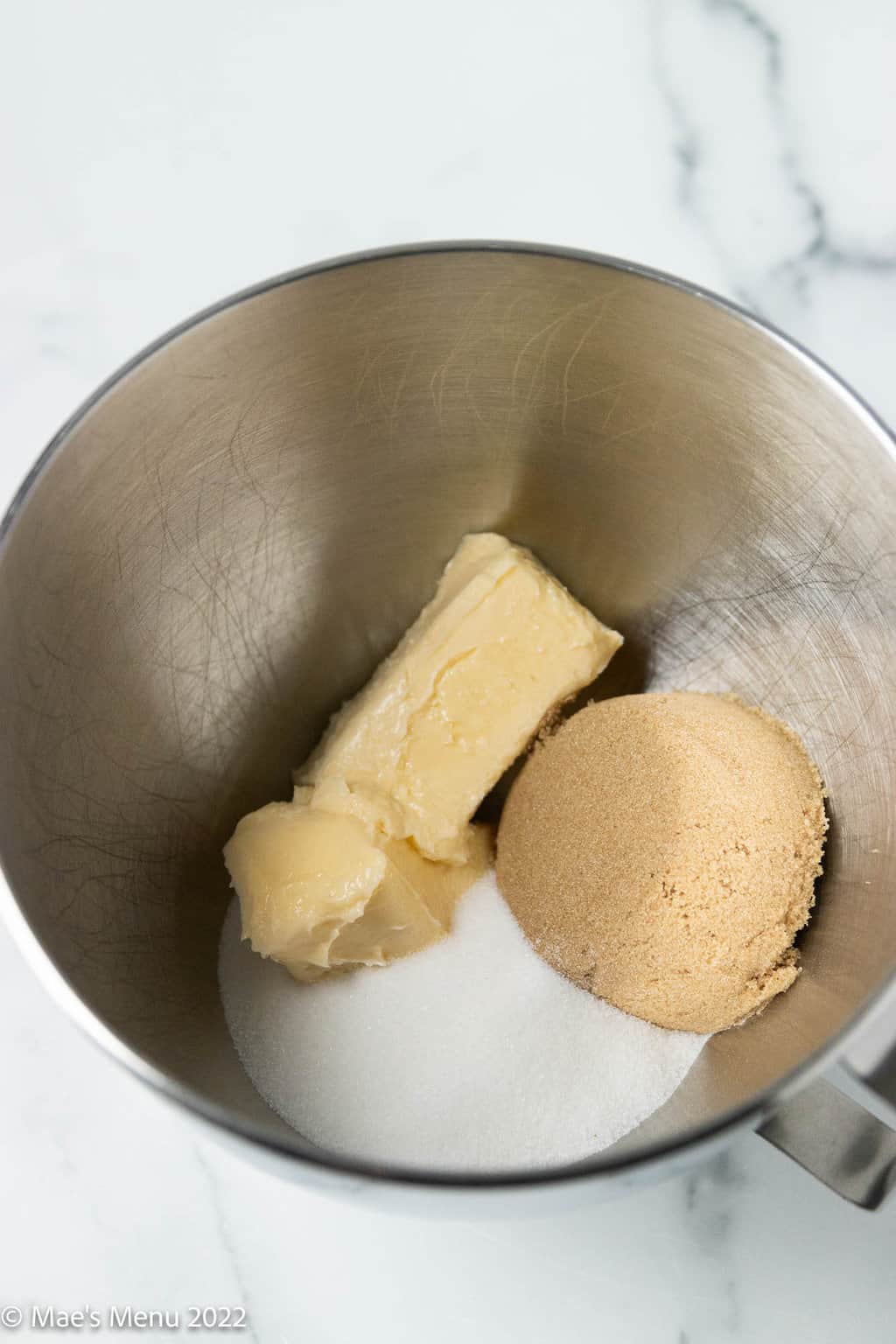 Vegan butter, brown sugar, and granulated sugar in a mixing bowl.