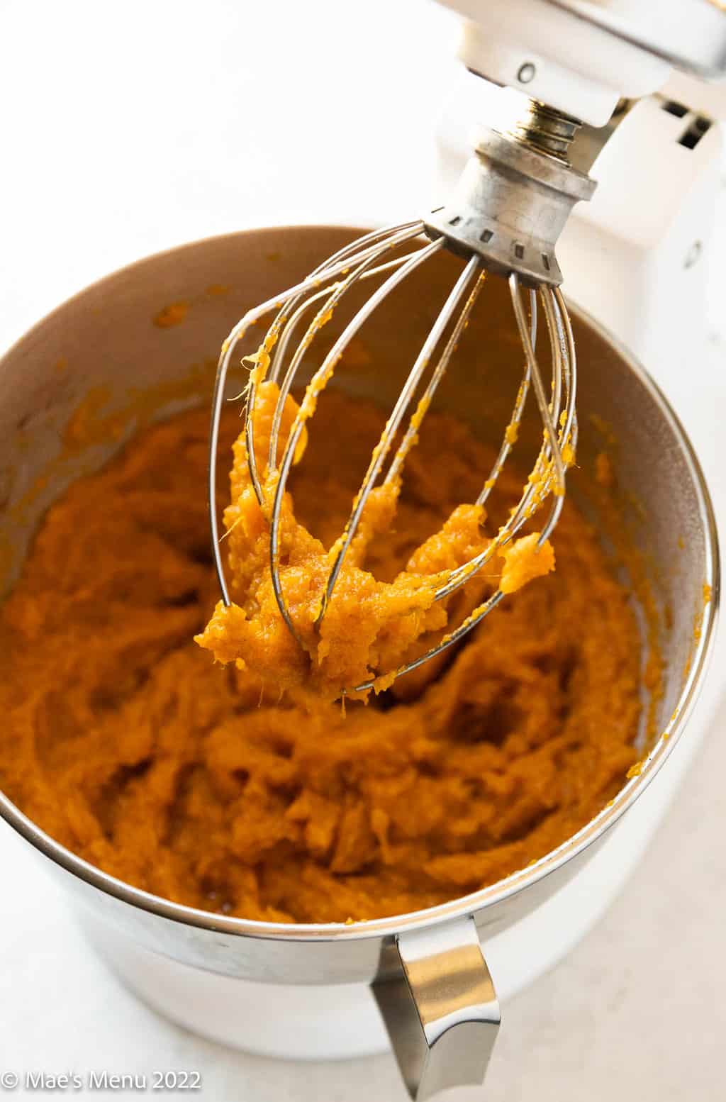 Whipped sweet potatoes in the bowl of a stand mixer.