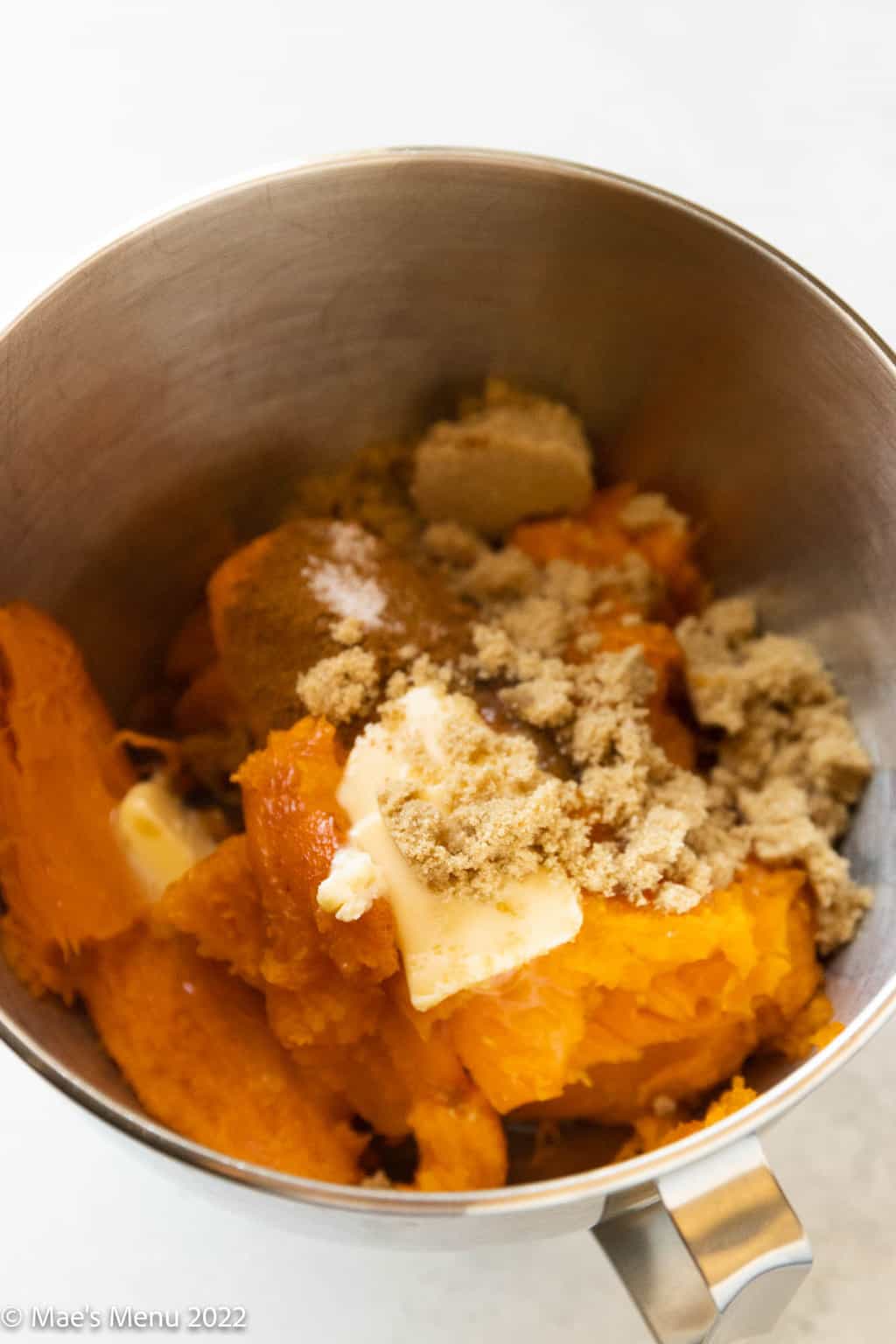 Sweet potato pulp in a stand mixer with butter, brown sugar, cinnamon, and salt.