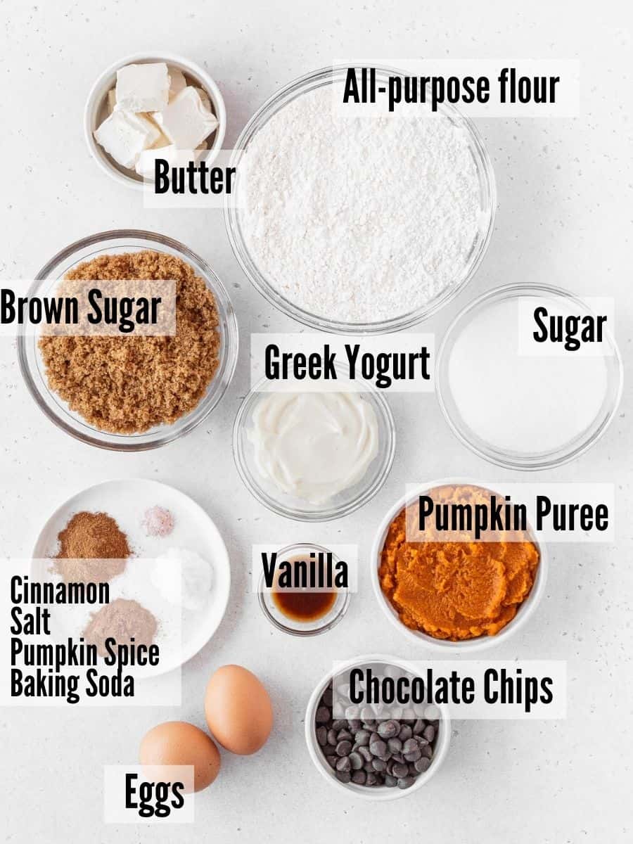 All of the ingredients for gluten free pumpkin muffins: flour, brown sugar, sugar, butter, pumpkin puree, greek yogurt, eggs, vanilla, chocolate chips, and spices.