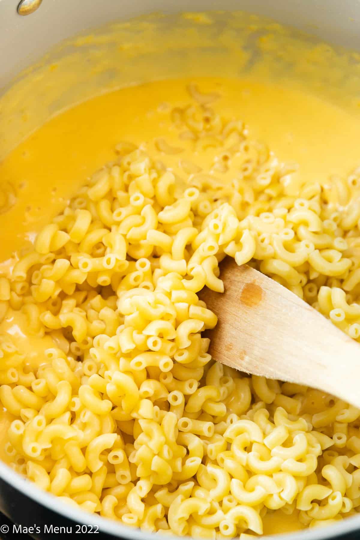 cooked macaroni added to cheese sauce.