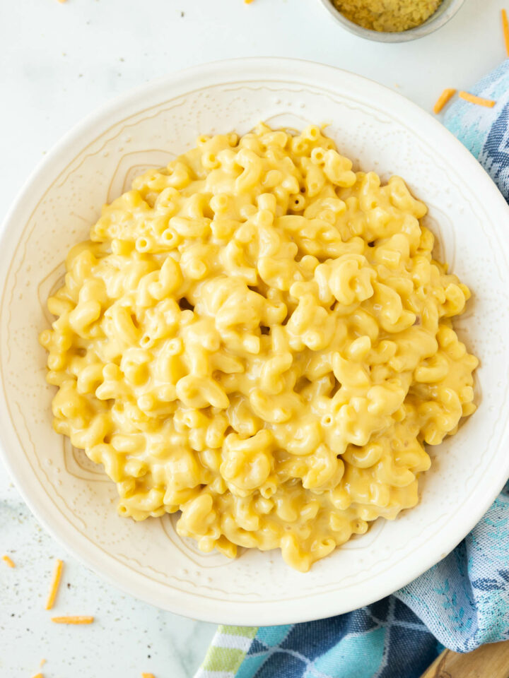 close up of lactose free mac and cheese with shreds of dairy free cheddar.