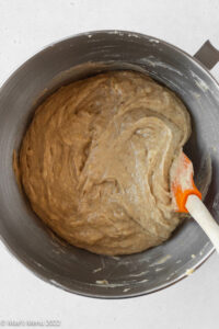 completed dairy-free banana muffin batter in the mixing bowl after stirring in the dry ingredients with a silicone spatula.