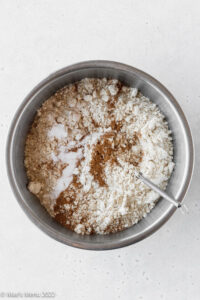 dry ingredients for making dairy-free banana muffins in a small mixing bowl with a whisk.
