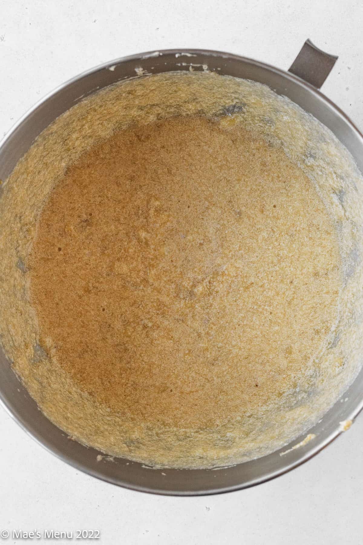 dairy-free banana bread muffin batter looks slightly broken and curdled after mixing in the remaining wet ingredients.