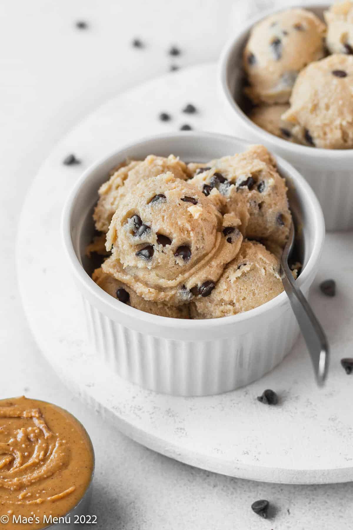 spoon in a bowl filled with scoops of edible cookie dough.