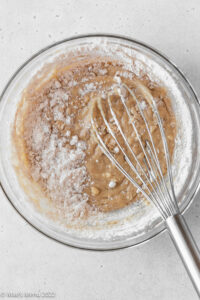 Whisking the flour into the creamed peanut butter mixture.