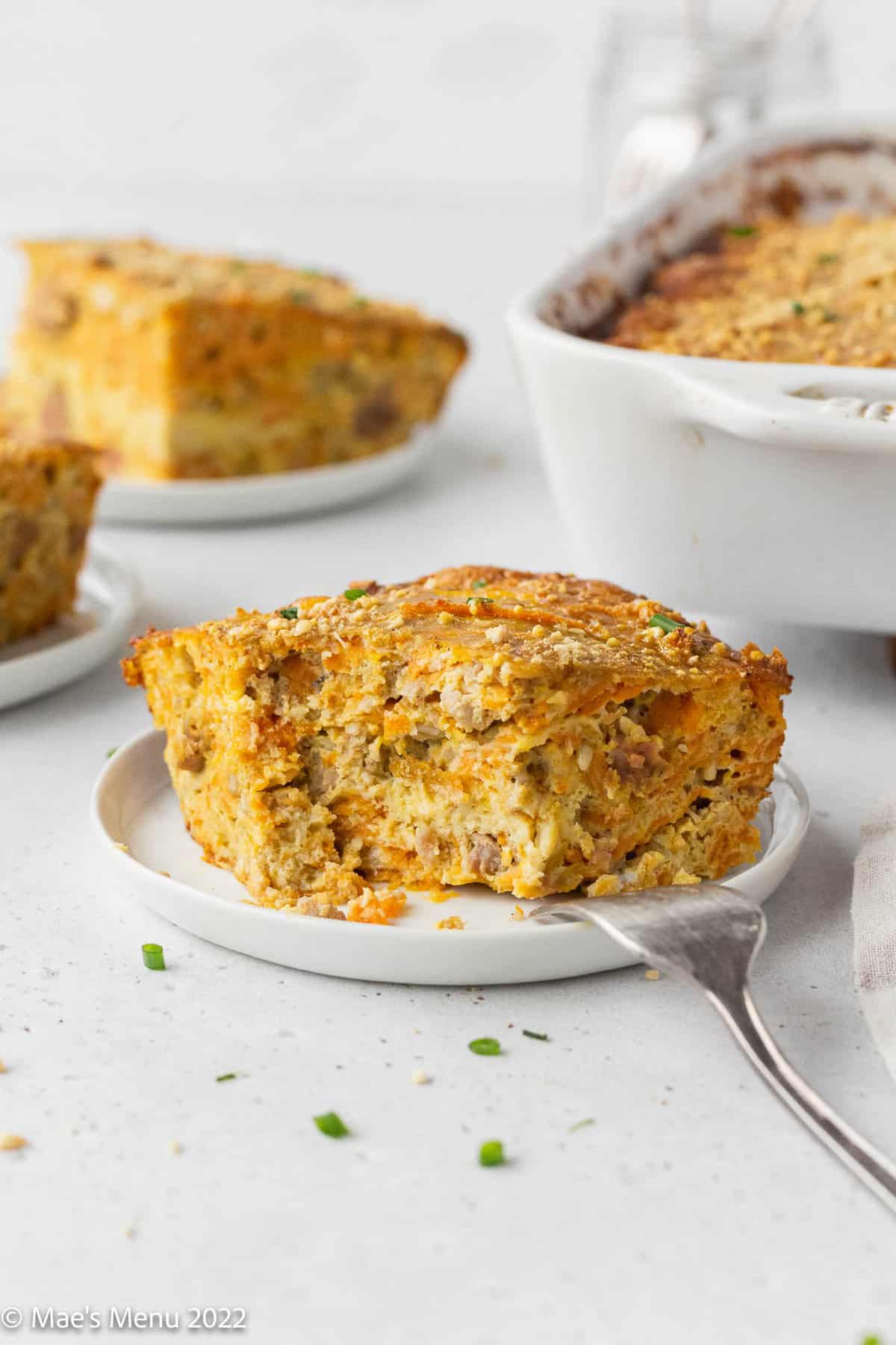 A large piece of dairy free breakfast casserole with a bite taken out of it.