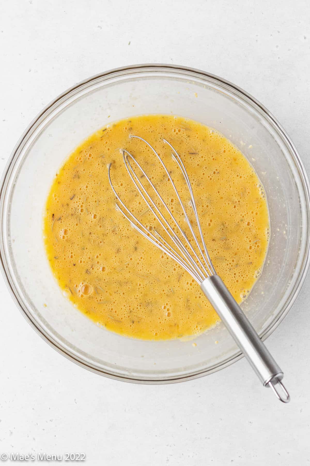 A whisking bowl of whisked eggs.