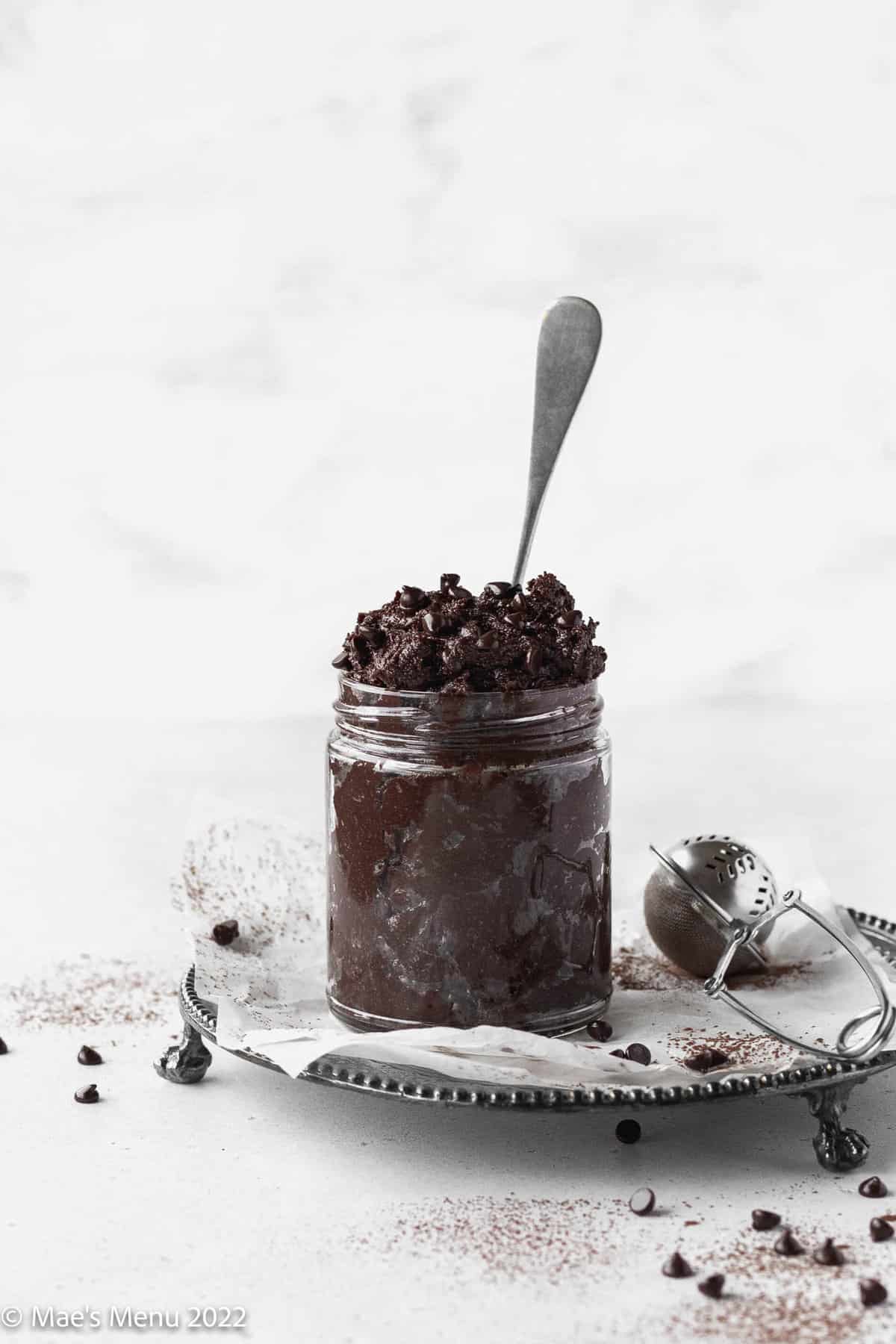 spoon in a jar of edible brownie batter made without eggs.