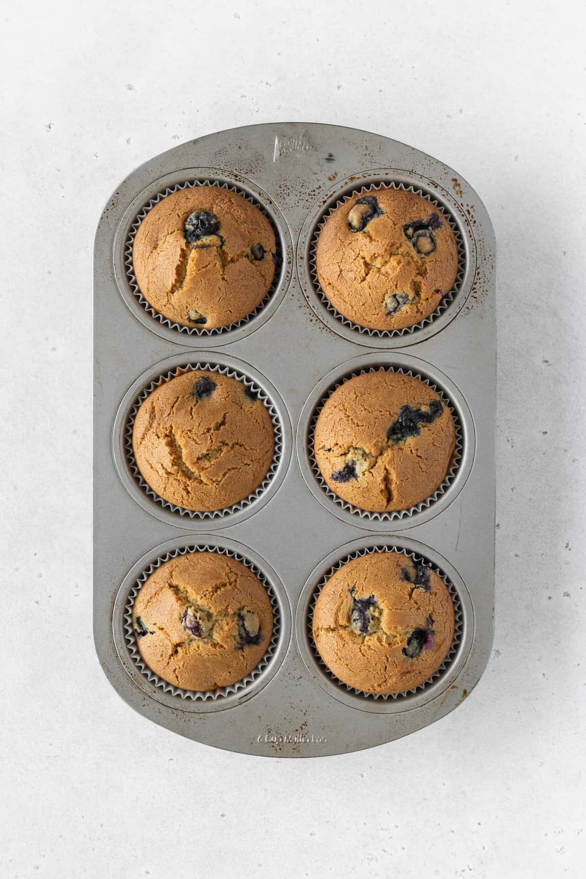 A muffin tray of dairy-free blueberry muffins.