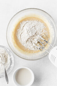 Mixing the flour into bowl of muffin batter.