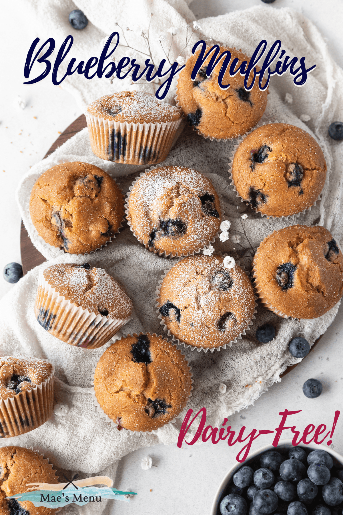 A pinterest pin for dairy-free blueberry muffins with an up-close overhead shot of the muffins on a towel.