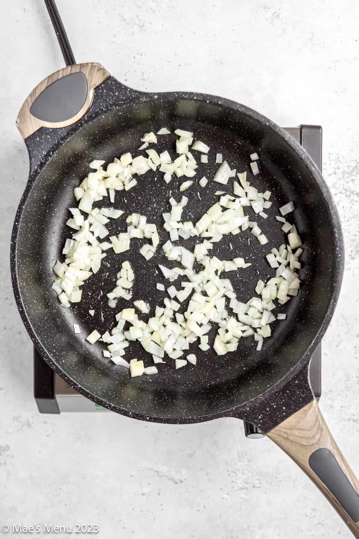 Sauteing onions on a skillet.