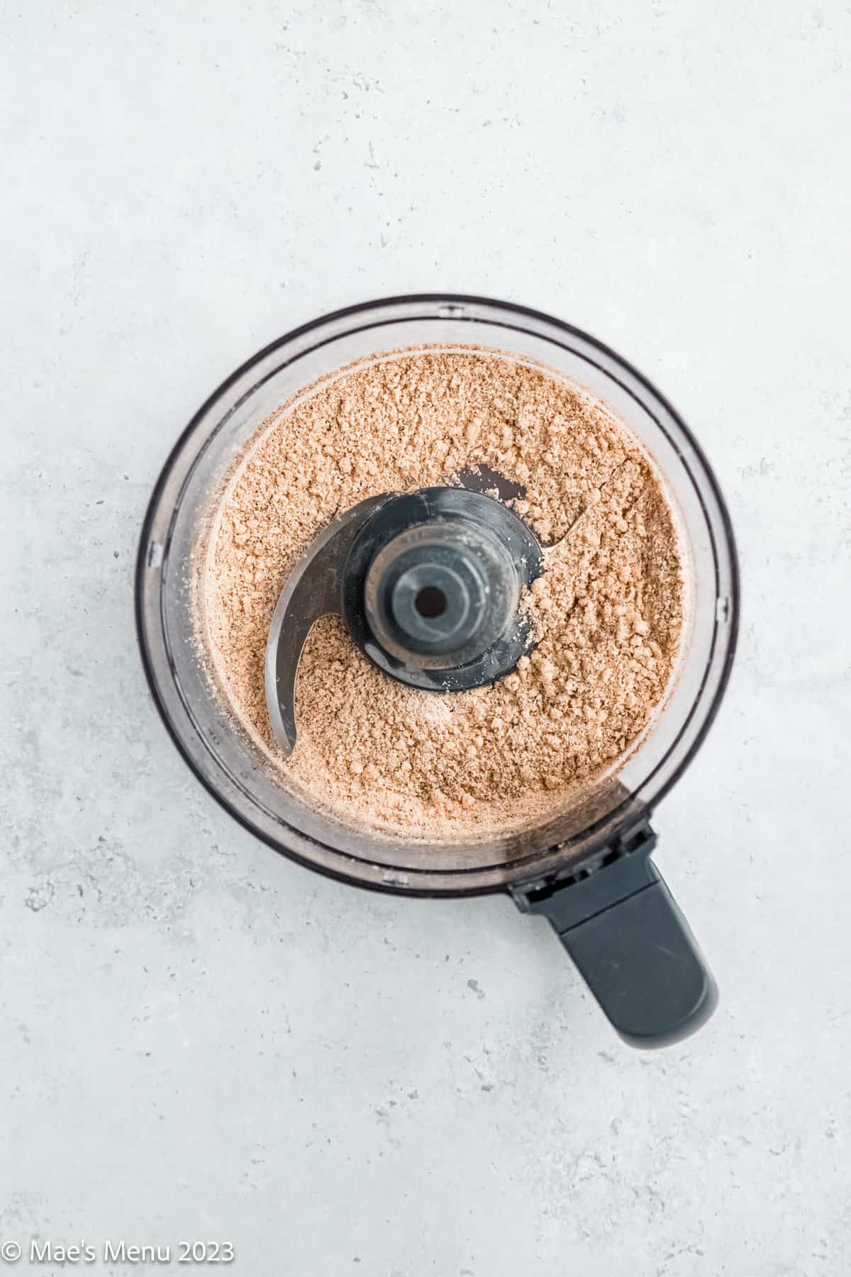 Blended walnuts and flour in a food processor.