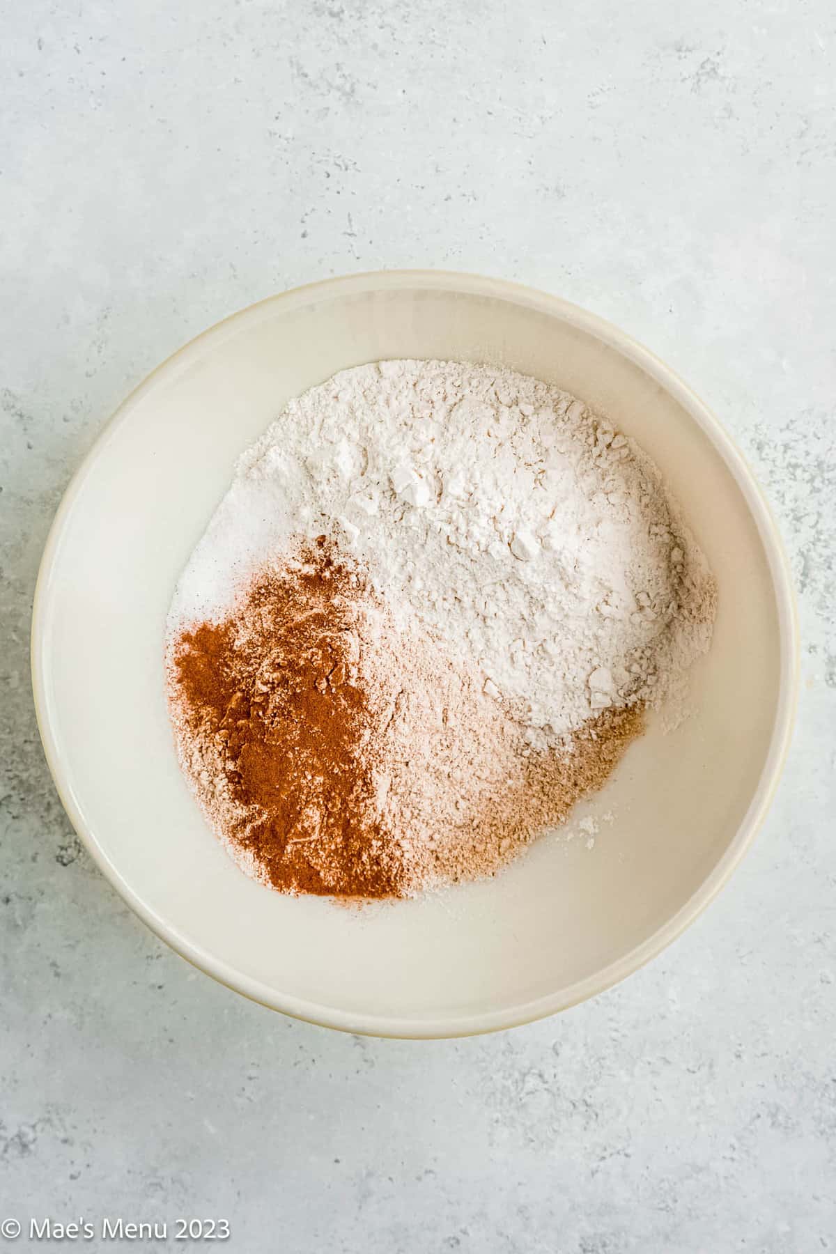 A large mixing bowl of flour, ground walnuts, cinnamon, and salt.