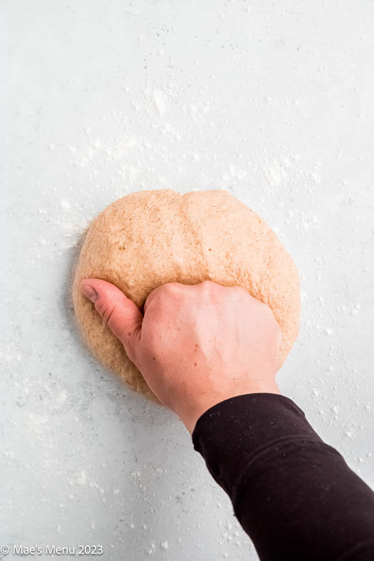 Kneading a ball of walnut bread dough.
